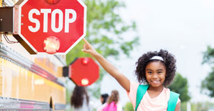 image of student pointing out stop sign on school bus