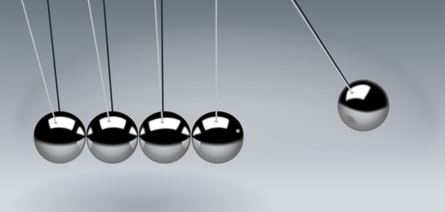 image of balls moving on a Newton's Cradle toy