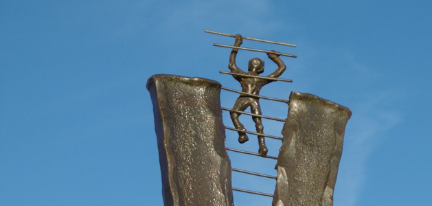 image of sculpture with human figure climbing ladder into sky